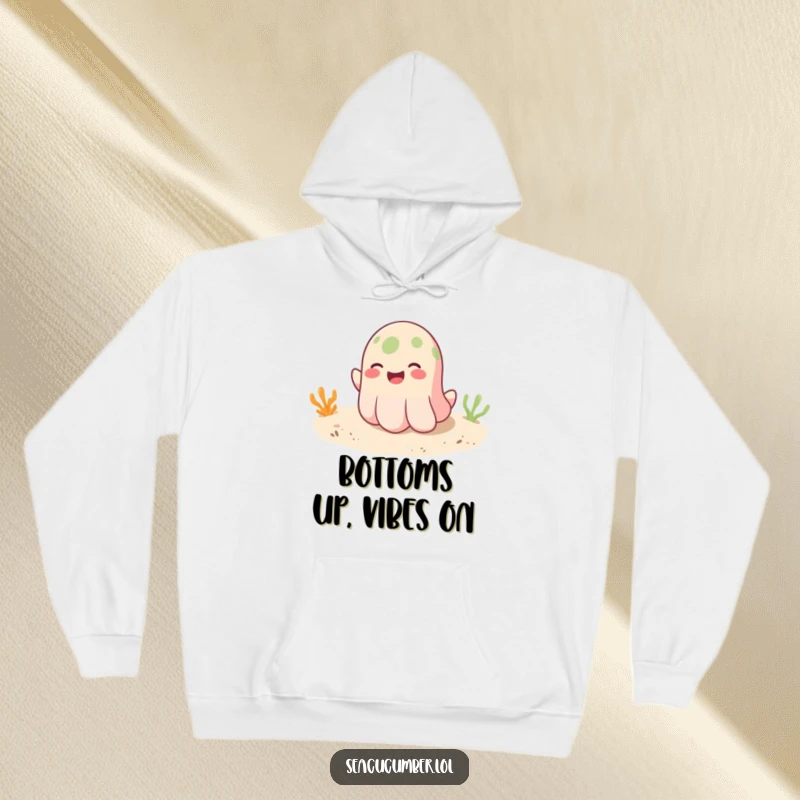 Funny hoodie showing a smiling seacucumber playfully bouncing on a sandy bottom, offering cozy comfort and cheerful vibes.